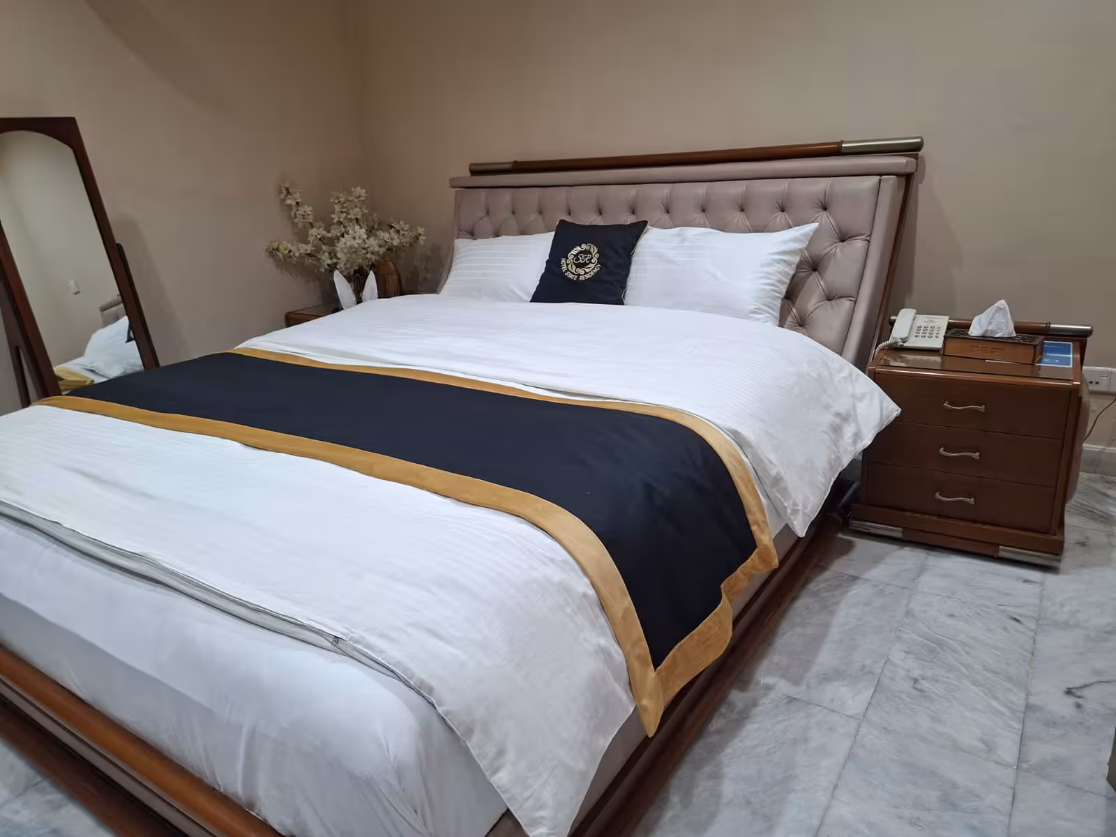 Luxury double bed room with tufted headboard and mirror dressing table - Hotel State Residency Bahawalpur