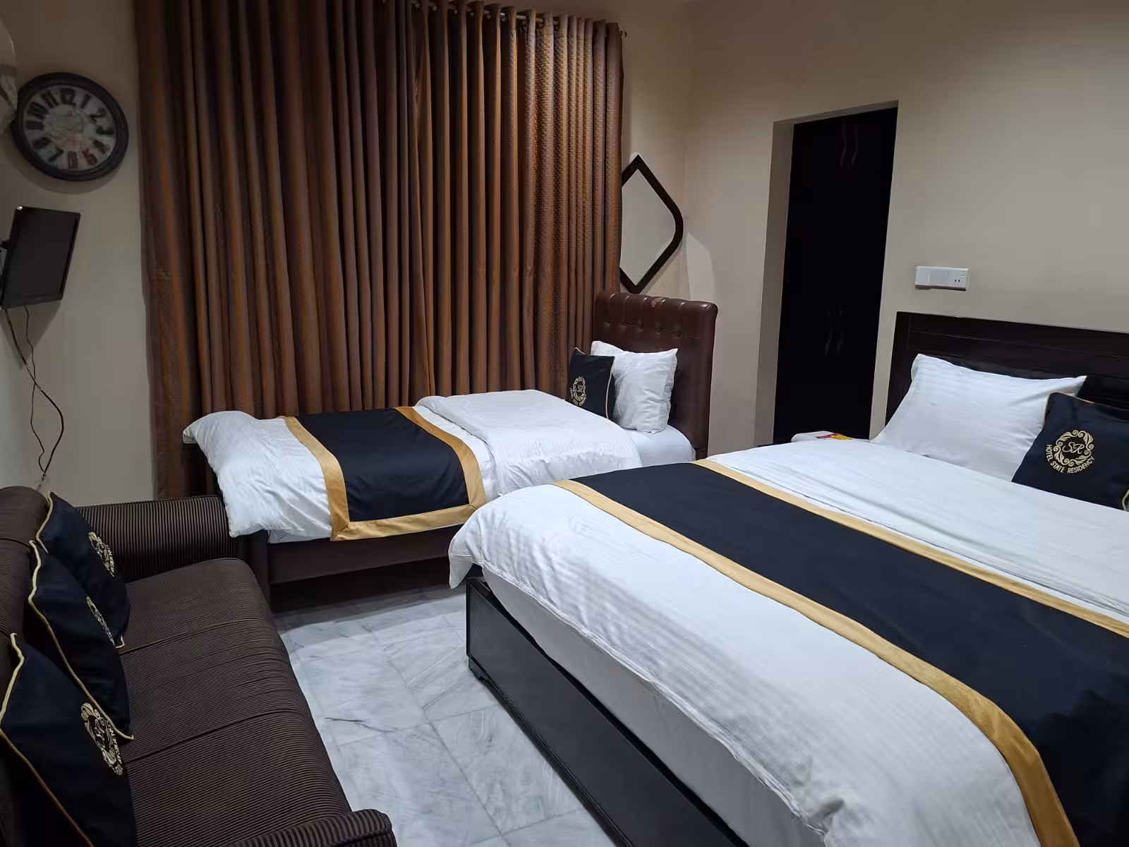 Twin bed room with elegant striped bedding at Hotel State Residency, Bahawalpur hotel
